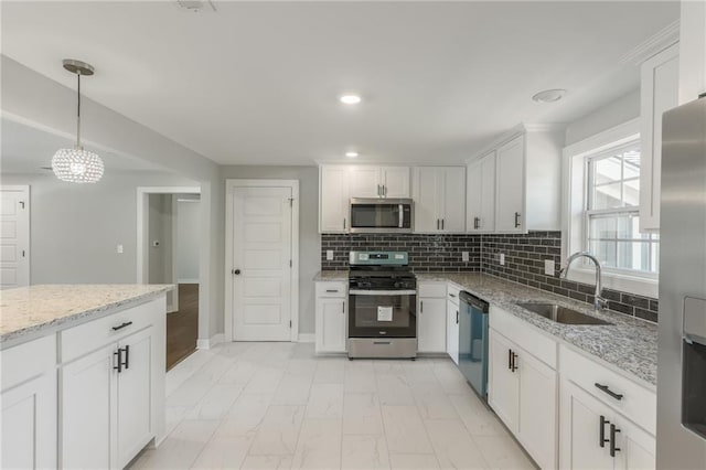 3414 Georgia Ave, Kansas City, KS 66104 - kitchen featuring appliances with stainless steel finishes, light marble finish floors, white cabinets, recessed lighting, and light stone countertops