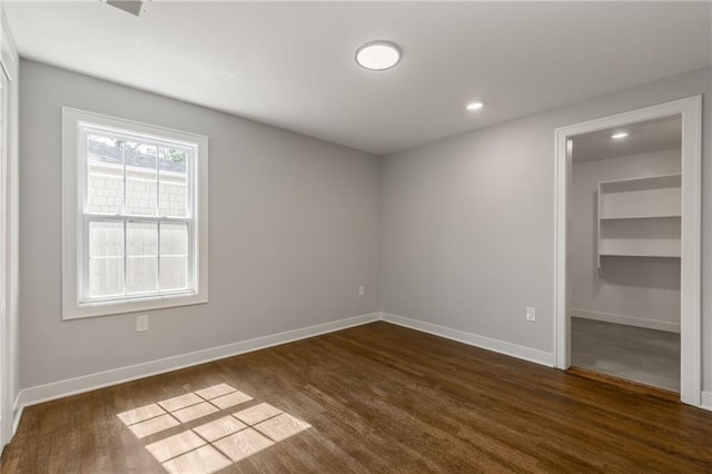 3414 Georgia Ave, Kansas City, KS 66104 - spare room with dark wood-style floors, built in features, and recessed lighting
