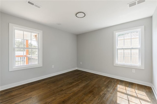 3414 Georgia Ave, Kansas City, KS 66104 - spare room featuring dark wood-style flooring and healthy amount of natural light
