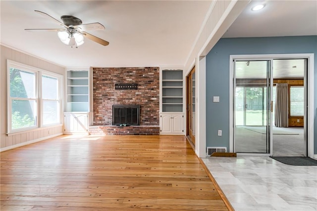 8224 Linden Dr, Prairie Village, KS 66208 - unfurnished living room with built in features, ceiling fan, a brick fireplace, light wood-style flooring, and recessed lighting