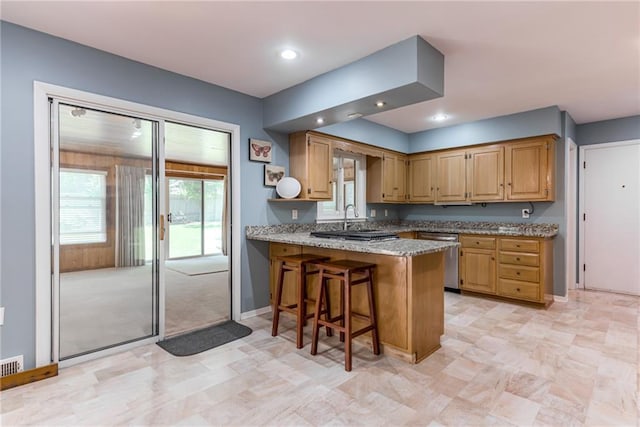 8224 Linden Dr, Prairie Village, KS 66208 - kitchen with stainless steel dishwasher, a peninsula, a kitchen breakfast bar, light stone counters, and recessed lighting