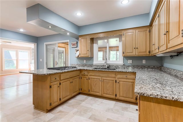 8224 Linden Dr, Prairie Village, KS 66208 - kitchen featuring stainless steel gas stovetop, a peninsula, light stone countertops, recessed lighting, and light floors