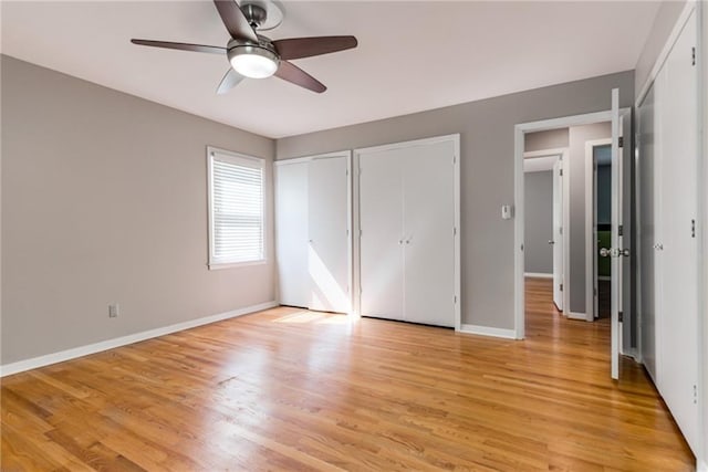 8224 Linden Dr, Prairie Village, KS 66208 - unfurnished bedroom with two closets, light wood-style flooring, and ceiling fan