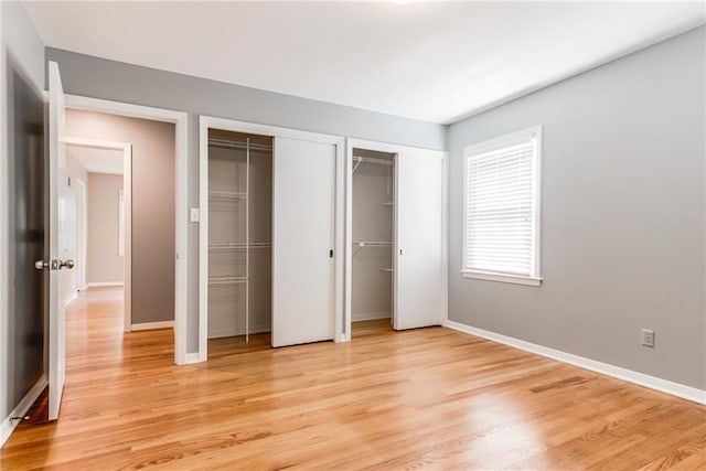 8224 Linden Dr, Prairie Village, KS 66208 - unfurnished bedroom with multiple closets and light wood-type flooring