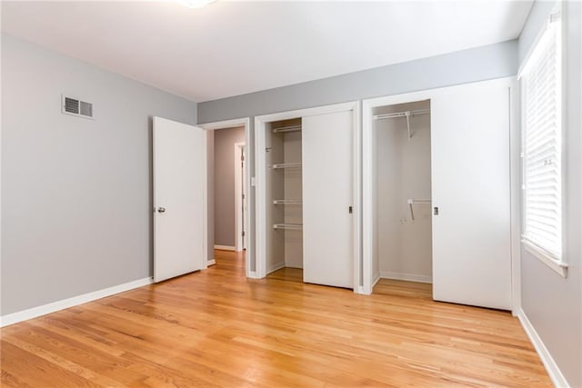 8224 Linden Dr, Prairie Village, KS 66208 - unfurnished bedroom with multiple closets and light wood-type flooring