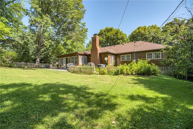 8224 Linden Dr, Prairie Village, KS 66208 - rear view of property featuring a chimney