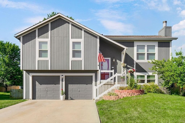 31241 W 172nd Ter, Gardner, KS 66030 - bi-level home featuring an attached garage, a front lawn, a chimney, and driveway