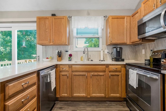 31241 W 172nd Ter, Gardner, KS 66030 - kitchen with stainless steel appliances, backsplash, light countertops, and dark wood-style floors