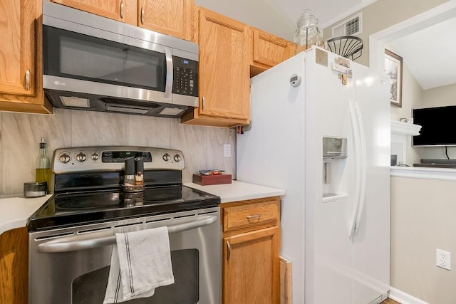 31241 W 172nd Ter, Gardner, KS 66030 - kitchen featuring appliances with stainless steel finishes, light countertops, and tasteful backsplash