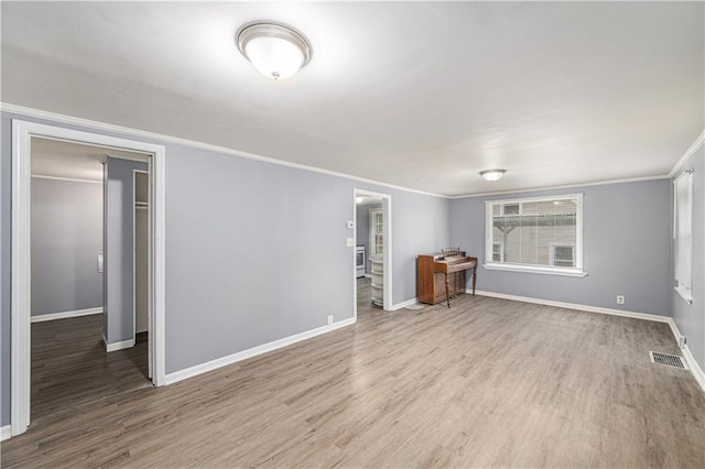 221 S High St, Independence, MO 64054 - unfurnished living room featuring crown molding and wood finished floors