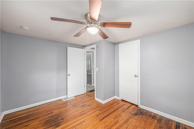 221 S High St, Independence, MO 64054 - unfurnished bedroom featuring wood finished floors, ceiling fan, and a closet