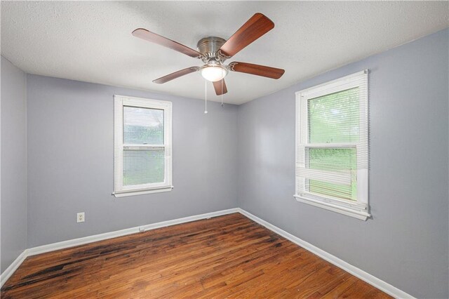 221 S High St, Independence, MO 64054 - unfurnished room with wood finished floors, ceiling fan, and a textured ceiling