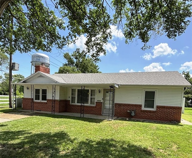 704 S Allen Ave, Chanute, KS 66720 - ranch-style house with brick siding, a front yard, a chimney, and a shingled roof