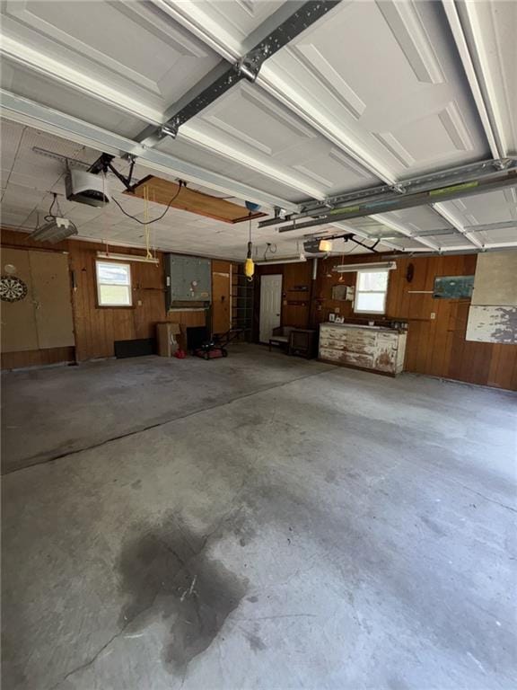 704 S Allen Ave, Chanute, KS 66720 - garage with wooden walls and a garage door opener