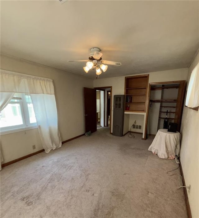 704 S Allen Ave, Chanute, KS 66720 - unfurnished bedroom featuring carpet floors and ceiling fan