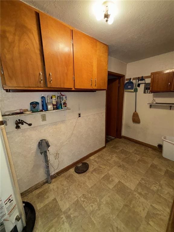 704 S Allen Ave, Chanute, KS 66720 - washroom featuring hookup for a washing machine, cabinet space, and a textured ceiling