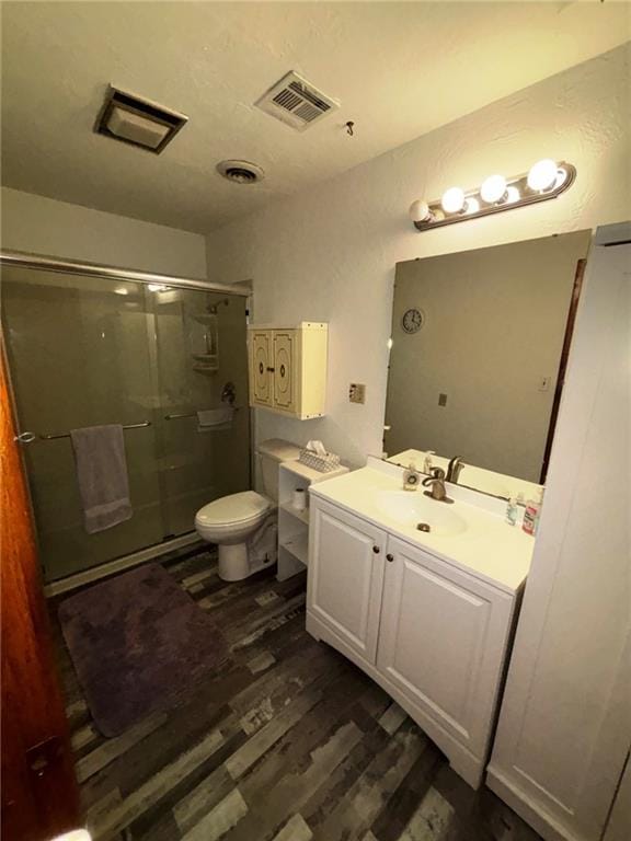 704 S Allen Ave, Chanute, KS 66720 - bathroom featuring wood finished floors, a shower stall, and vanity