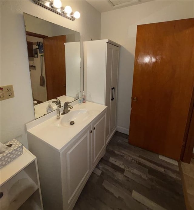 704 S Allen Ave, Chanute, KS 66720 - bathroom featuring wood finished floors and vanity