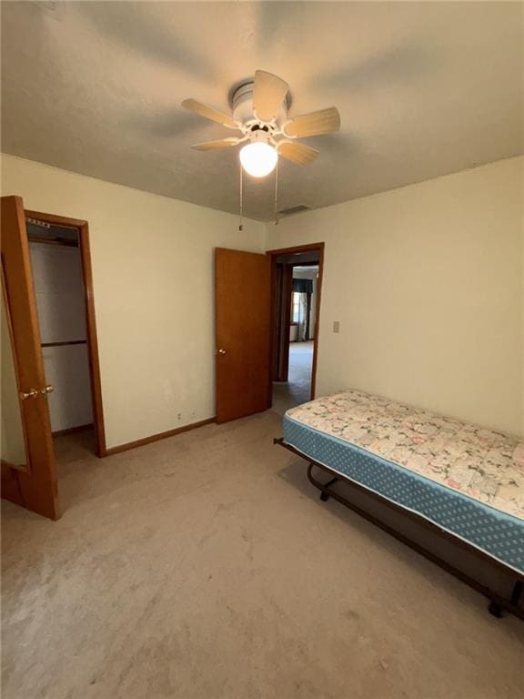 704 S Allen Ave, Chanute, KS 66720 - bedroom with light colored carpet and a ceiling fan