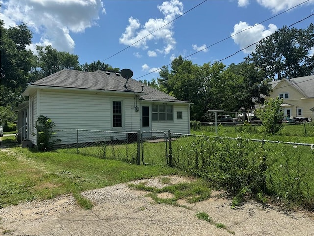 515 W 7th Ave, Garnett, KS 66032 - back of property featuring roof with shingles and a gate