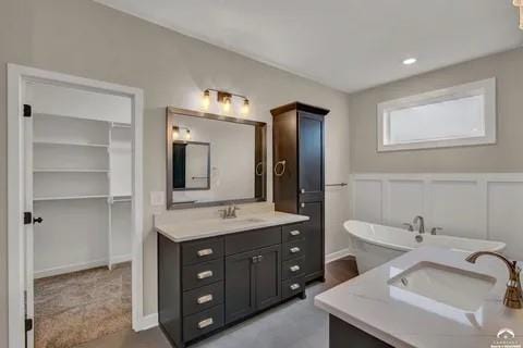 25446 W 91st Ter, Lenexa, KS 66227 - full bathroom with two vanities, a freestanding tub, wainscoting, and a decorative wall