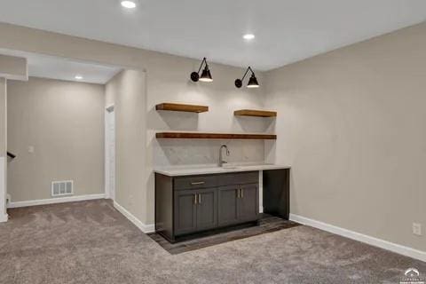 25446 W 91st Ter, Lenexa, KS 66227 - indoor wet bar with carpet flooring and recessed lighting