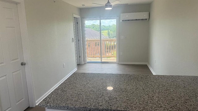1106 S Mitchell St, Warrensburg, MO 64093 - unfurnished room with a wall unit AC, ceiling fan, and dark wood-style flooring