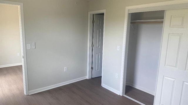 1106 S Mitchell St, Warrensburg, MO 64093 - unfurnished bedroom with dark wood-type flooring and a closet