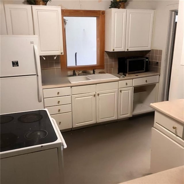 2125 N 45th St, Kansas City, KS 66104 - kitchen featuring white appliances, decorative backsplash, white cabinets, and light countertops