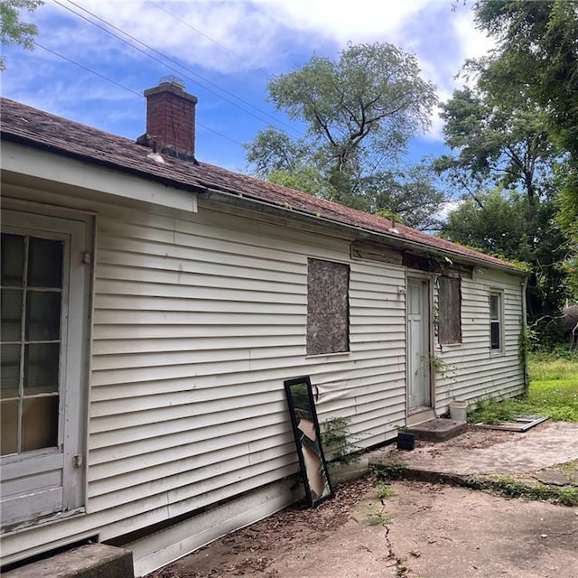 2125 N 45th St, Kansas City, KS 66104 - view of property exterior with a chimney