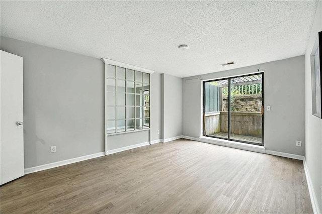 12704 W 110th Ter, Overland Park, KS 66210 - unfurnished room featuring a textured ceiling and wood finished floors