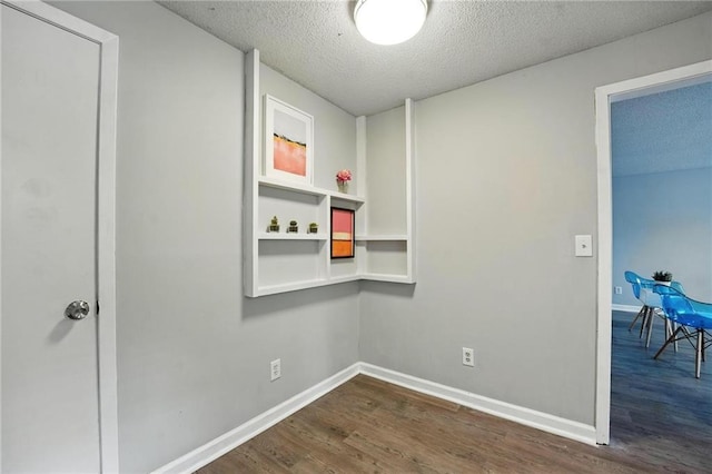12704 W 110th Ter, Overland Park, KS 66210 - unfurnished room with dark wood finished floors and a textured ceiling