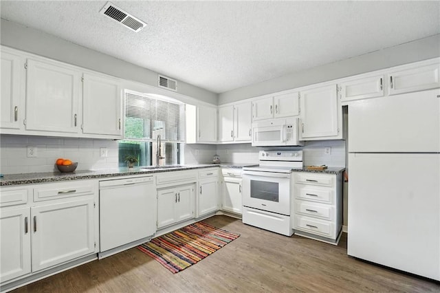 12704 W 110th Ter, Overland Park, KS 66210 - kitchen with white appliances, white cabinetry, dark wood-style floors, tasteful backsplash, and a textured ceiling