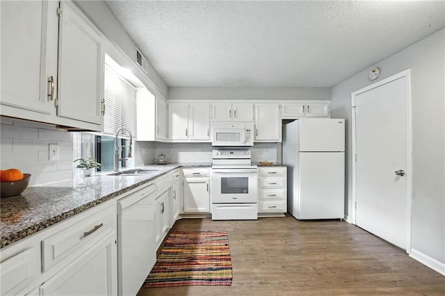 12704 W 110th Ter, Overland Park, KS 66210 - kitchen featuring white appliances, a textured ceiling, light stone counters, dark wood finished floors, and white cabinets