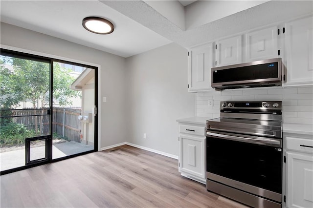 11016 W 96th Ter, Overland Park, KS 66214 - kitchen with appliances with stainless steel finishes, decorative backsplash, light countertops, white cabinetry, and light wood-type flooring