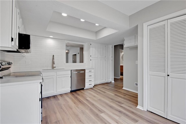 11016 W 96th Ter, Overland Park, KS 66214 - kitchen with stainless steel dishwasher, electric stove, a raised ceiling, tasteful backsplash, and white cabinetry