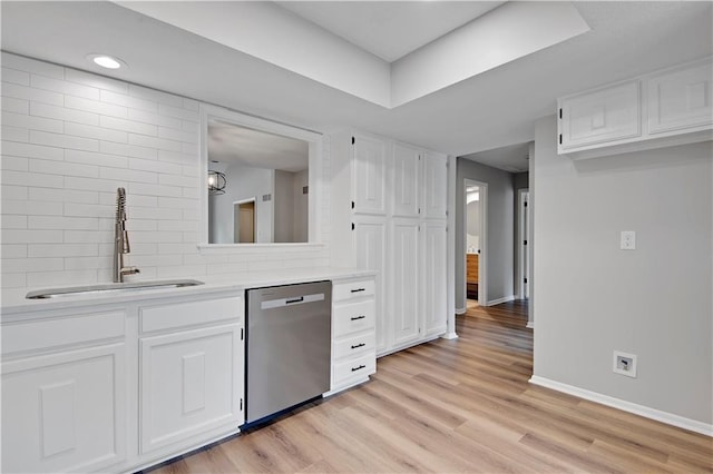 11016 W 96th Ter, Overland Park, KS 66214 - kitchen featuring stainless steel dishwasher, light wood-style floors, white cabinets, light countertops, and a tray ceiling