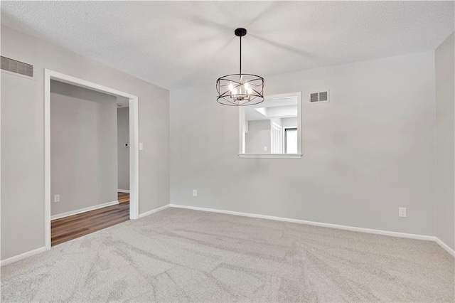 11016 W 96th Ter, Overland Park, KS 66214 - spare room with carpet flooring, a chandelier, and a textured ceiling