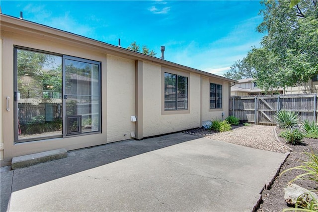 11016 W 96th Ter, Overland Park, KS 66214 - rear view of house featuring stucco siding and a patio