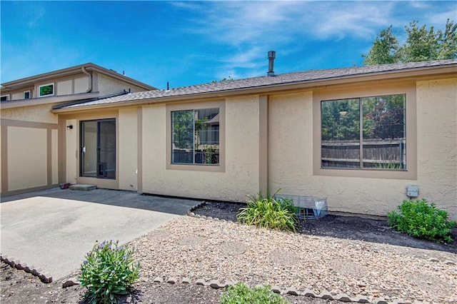 11016 W 96th Ter, Overland Park, KS 66214 - back of property with stucco siding and a patio area
