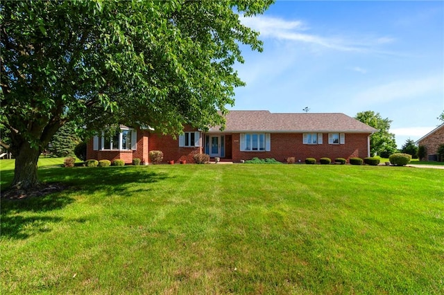 205 E 10th St, Carrollton, MO 64633 - single story home with a front yard and brick siding