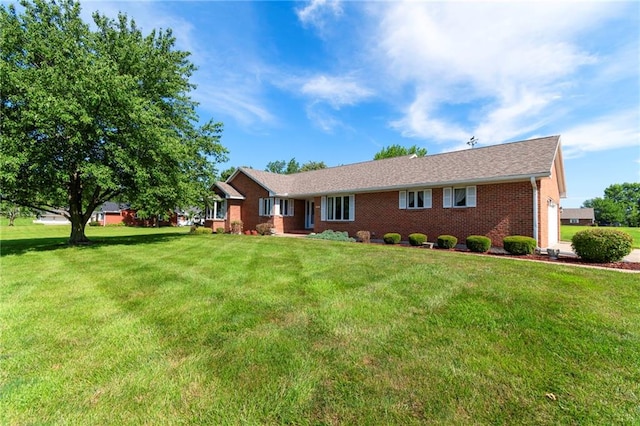 205 E 10th St, Carrollton, MO 64633 - single story home with a front yard and brick siding