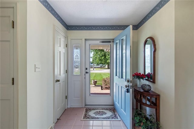 205 E 10th St, Carrollton, MO 64633 - foyer entrance with light tile patterned floors and a textured ceiling