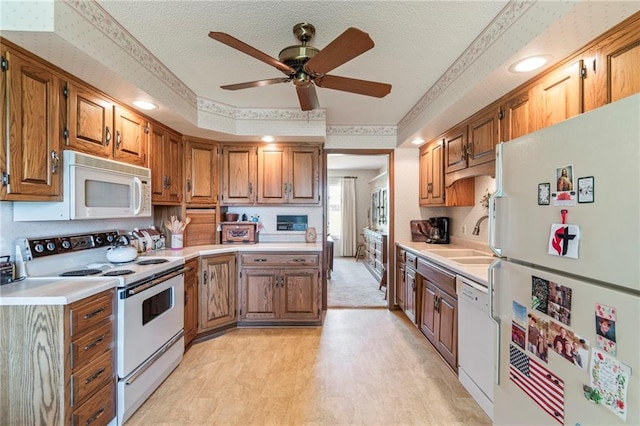 205 E 10th St, Carrollton, MO 64633 - kitchen with white appliances, light countertops, a ceiling fan, a textured ceiling, and brown cabinetry
