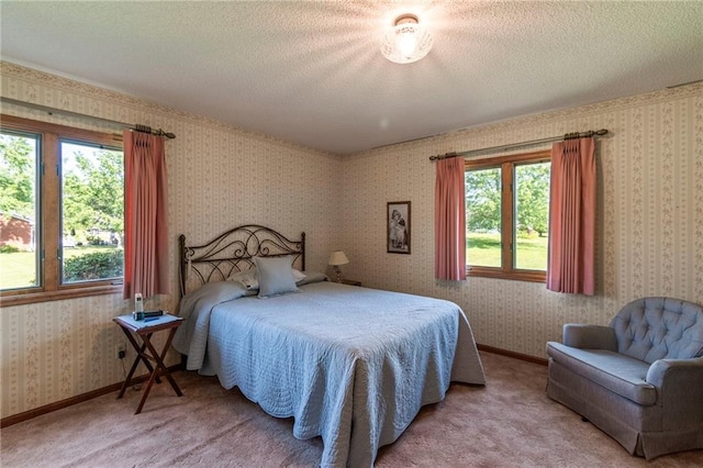 205 E 10th St, Carrollton, MO 64633 - carpeted bedroom with a textured ceiling and wallpapered walls