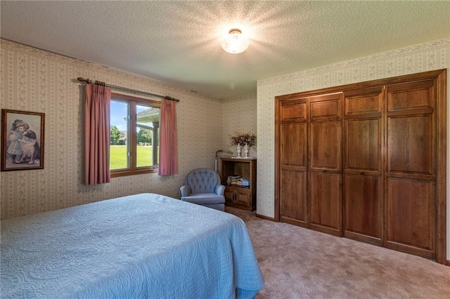 205 E 10th St, Carrollton, MO 64633 - carpeted bedroom featuring wallpapered walls, a textured ceiling, and a closet