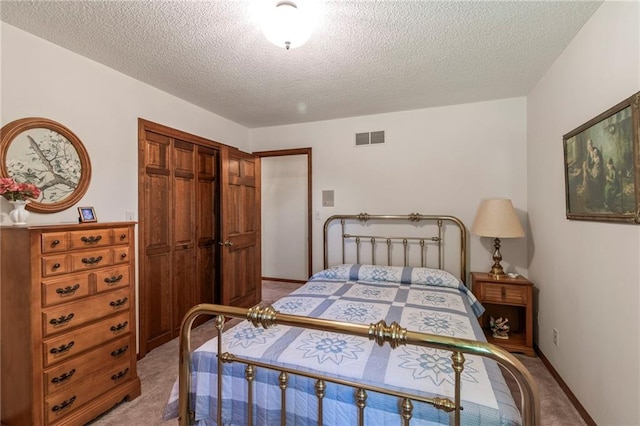 205 E 10th St, Carrollton, MO 64633 - bedroom with light colored carpet, a textured ceiling, and a closet