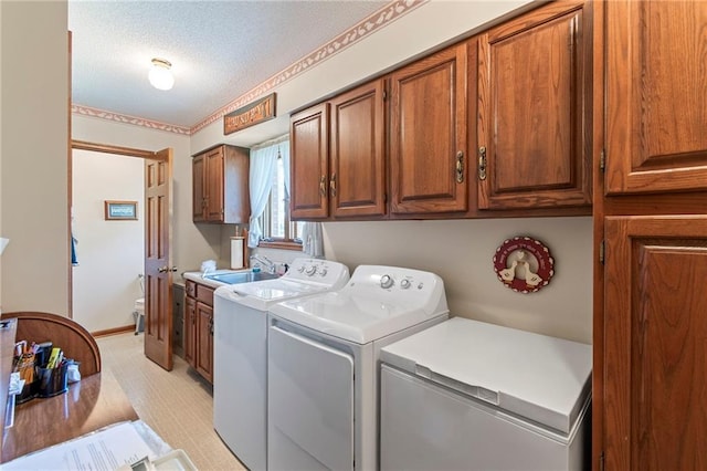 205 E 10th St, Carrollton, MO 64633 - laundry area with washing machine and clothes dryer, cabinet space, and a textured ceiling