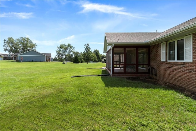 205 E 10th St, Carrollton, MO 64633 - view of green lawn featuring a sunroom