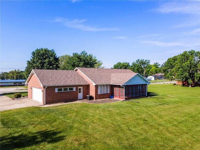 205 E 10th St, Carrollton, MO 64633 - single story home featuring a front yard, concrete driveway, brick siding, a garage, and a shingled roof